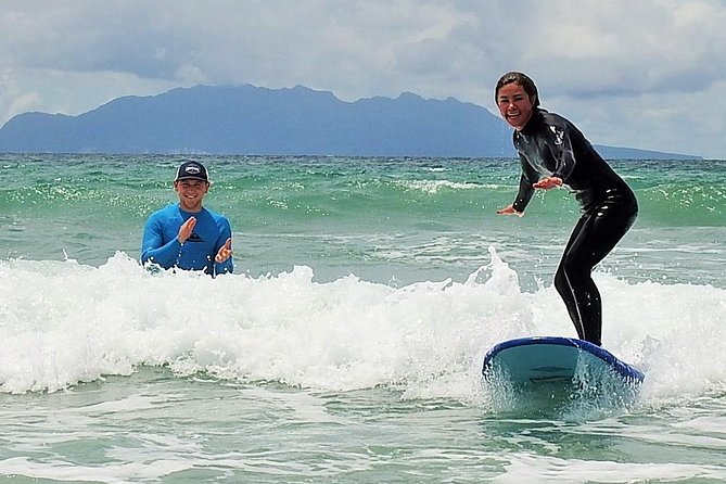 Beginner Surf Lesson at Te Arai Beach - Taking the board into the ocean