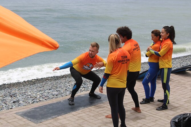 Beginner Surf Lesson in Lima, Perú - Wetsuits, aqua shoes, and boards are included