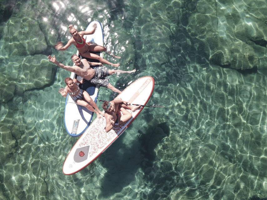 From Ornos: Mykonos Delos Catamaran Cruise with Meal & SUP - Rhenia: the day’s main stop