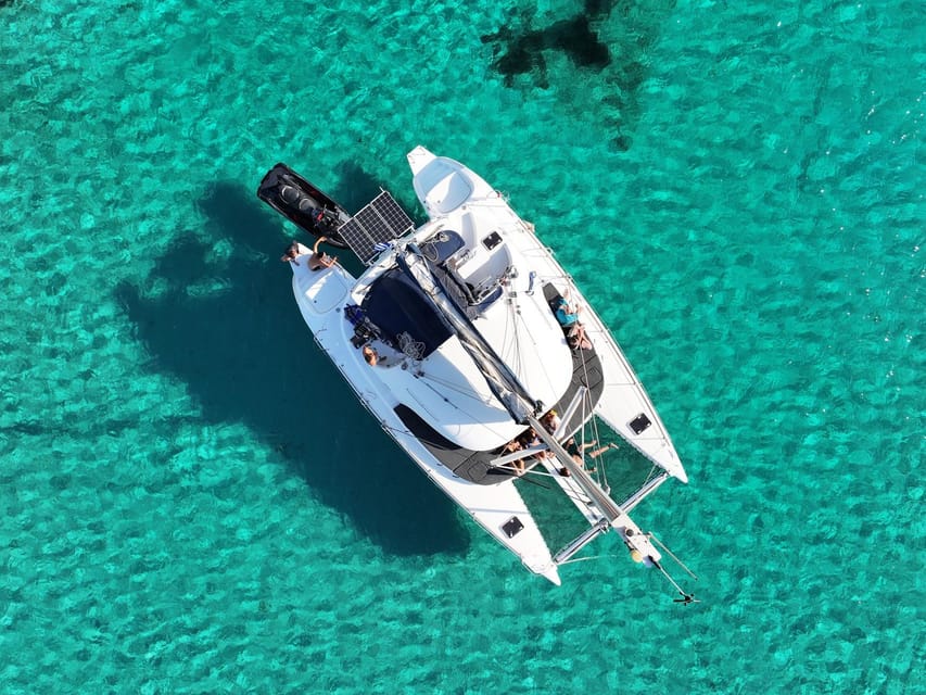 From Ornos: Mykonos Delos Catamaran Cruise with Meal & SUP - Greek food served on the catamaran