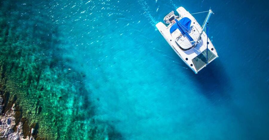 From Ornos: Mykonos Delos Catamaran Cruise with Meal & SUP - Passing Delos without going ashore