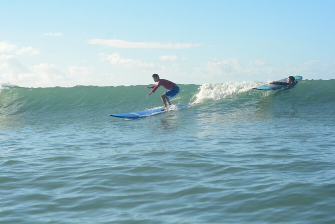 Group Surf Lesson at Kalama Beach in Kihei - Catching waves in warm, waist-deep water
