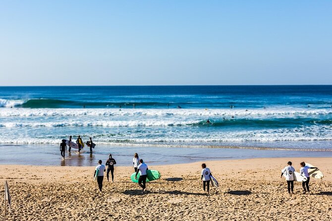 Group Surf Lesson in Costa da Caparica - Practicing the stand-up on the sand
