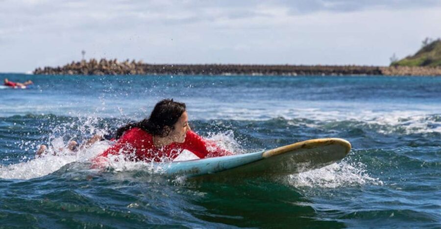 Kalapaki Beach: Surfing Lesson with Kauai Beach Boys - Getting equipped with a board, leash, and rash guard