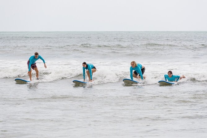 Learn to Surf at Coolangatta on the Gold Coast - Catching small waves in waist-deep water