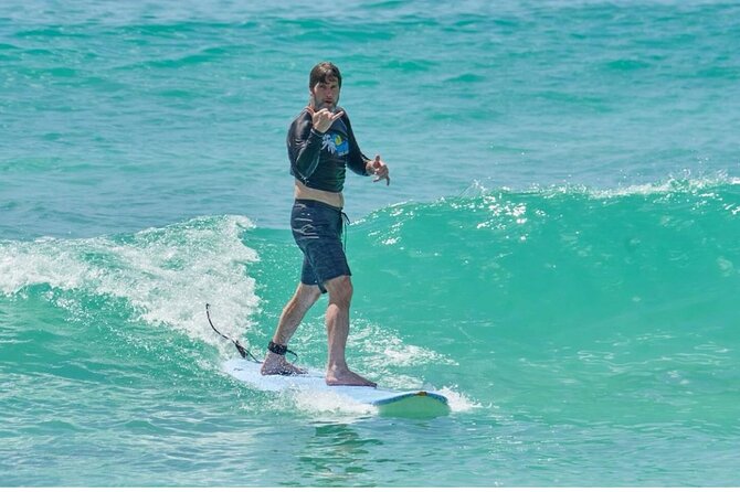 Learn to Surf in Paradise. - Board, rashguard, and what you still need