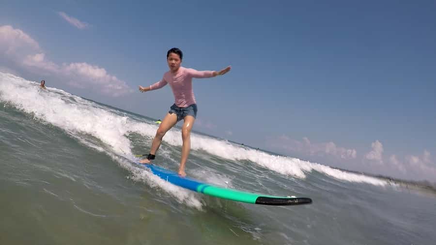 Legian Beach, Bali: Beginner or Intermediate Surf Lessons - Taking the softboard into the waves
