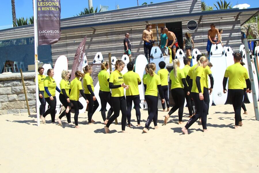 Lisbon: Guided Surfing Tour & Lessons - Caparica in summer: broad sand and a bridge crossing