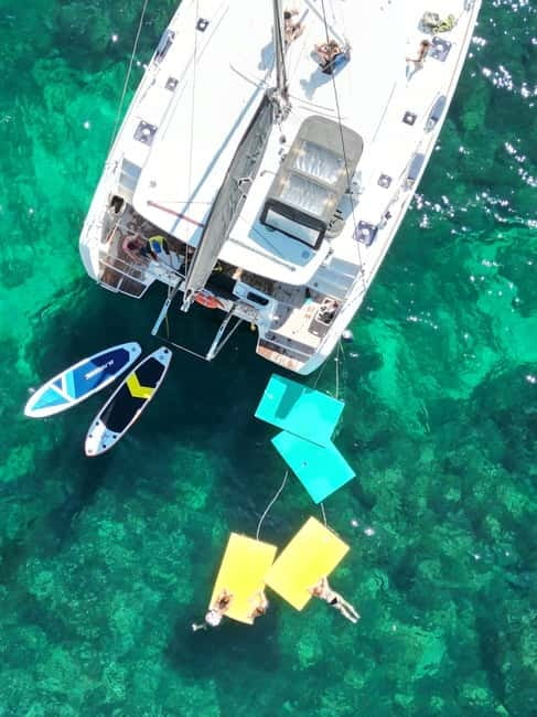 Majorca: Dinner aboard a private catamaran with snorkeling and paddle surfing - Seafood dinner as the sun sets