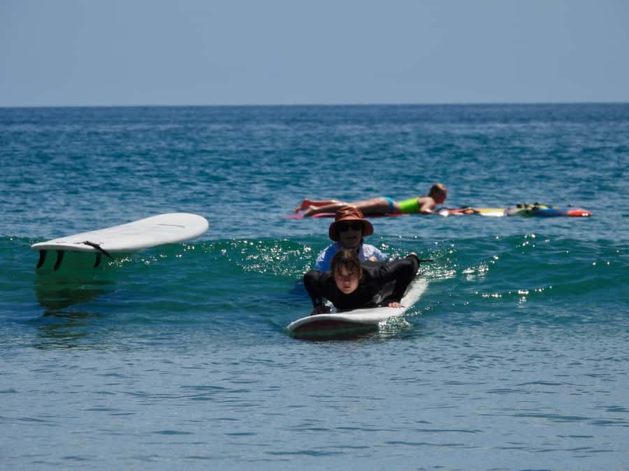 Mount Maunganui: Group Beginner Surf Lesson - Moving from the sand into the water