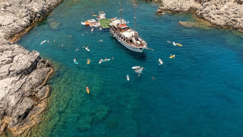 Rhodes: Gulet Trip with Food, Drinks, SUP, Kayak & Swimming - Ladiko’s Fun Island gives you two hours to play