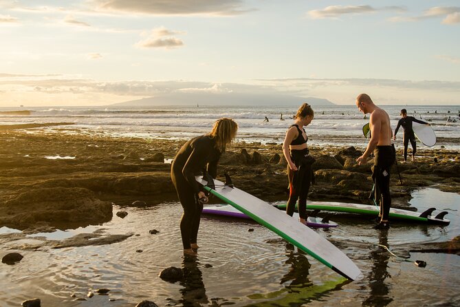 Small Group Surf Lesson in Playa de las Américas - Getting ready with a board and wetsuit