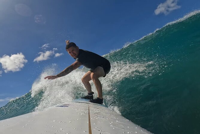 Surf Lessons get your Social Media video & photos you Surfing HI. - Entering the water with paddle assistance