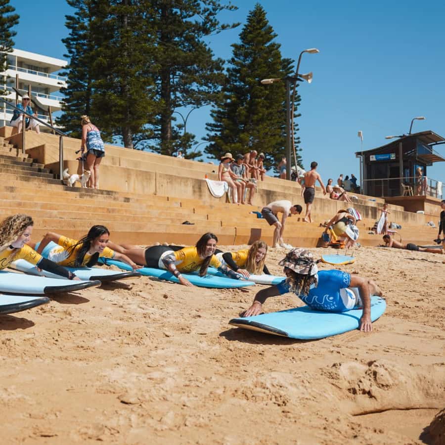 Sydney: Dee Why Beach Group Surfing Lesson - Learning to pop up and catch a wave