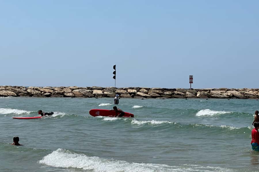 Tel Aviv: Professional Surfing Lessons at Beach Club TLV - Taking the soft-top board into the waves